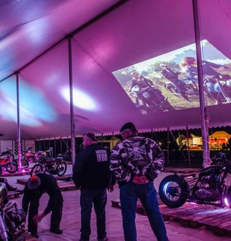 Pole marquee for a motorcycle festival with purple mood lighting