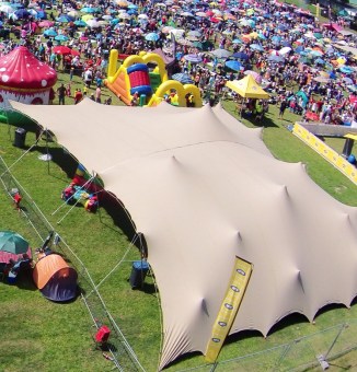 Tan stretch tent being used for a VIP holding area in London before a concert